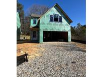 A home's exterior showing the two-car garage and construction materials at 3017 Abelia Dr, Buford, GA 30519