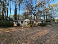 Charming brick home with a covered porch and mature trees in a serene wooded setting at 3195 Benjamin E Mays Sw Dr, Atlanta, GA 30311