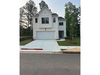 Charming two-story home with a modern white facade and a spacious driveway at 4315 Easter Lily Ave, Buford, GA 30519