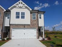 Charming two-story townhome featuring a brick facade and a spacious two-car garage at 328 Sinclair Ct # 78, Mcdonough, GA 30253