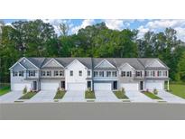 Charming townhomes featuring a variety of color schemes and attached garages, complemented by manicured front lawns at 344 Sinclair Ct # 74, Mcdonough, GA 30253