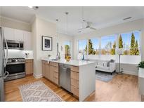 Modern kitchen with stainless steel appliances, light wood cabinets, and a kitchen island open to the living room at 384 Ralph Mcgill Ne Blvd # 314, Atlanta, GA 30312