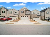 Attractive townhomes feature attached garages and manicured lawns under a sunny sky at 1120 Sunny Lake Dr, Lawrenceville, GA 30043