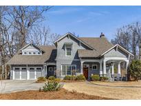 Beautifully landscaped two-story home with a three car garage and a charming front porch at 2109 Rugby St, Atlanta, GA 30309