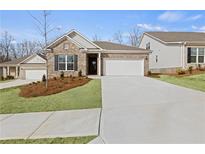 Charming single-story home with a well-manicured front yard, attached garage, and neutral brick facade at 189 Park Ln, Fairburn, GA 30213