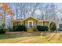 Charming brick home with manicured landscaping, inviting entrance, and a well-maintained lawn at 2048 Edgemore Se Dr, Atlanta, GA 30316