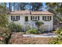 Charming home with a beautiful front yard, inviting entrance, and convenient attached garage at 2484 Oldfield Nw Rd, Atlanta, GA 30327