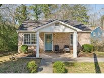 Charming brick home featuring a covered front porch and a well-maintained landscaped front yard at 3261 Lowndes St, Atlanta, GA 30337