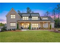 Stunning brick and siding home with a welcoming front porch and manicured lawn at 39 Telfair Ct, Acworth, GA 30101