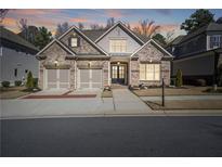 Charming brick home with a two-car garage and inviting front entrance at 10570 Grandview Sq, Johns Creek, GA 30097