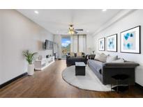 Bright living room with hardwood floors, ceiling fan, comfortable seating, and access to a balcony at 1501 Clairmont Rd # 1027, Decatur, GA 30033