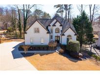 Charming two-story home with white exterior, landscaped yard, and a well-manicured lawn at 2422 Tall Timbers Trl, Marietta, GA 30066