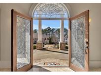 Grand entrance featuring decorative glass doors and view of circular driveway and landscaped front yard at 426 Lanesborough Dr, Marietta, GA 30064