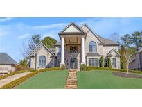 Stately brick home with a covered front porch, featuring elegant columns and landscaped grounds at 426 Lanesborough Dr, Marietta, GA 30064