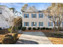 Charming home featuring neutral siding, light blue shutters, and a well-maintained front yard at 4403 Thorngate Ln, Acworth, GA 30101