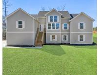 Charming two-story home featuring double-hung windows and a well-manicured lawn at 939 Whistler Ln, Canton, GA 30114