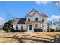 Charming two-story home with a welcoming front porch and well-manicured lawn in a lovely neighborhood at 2005 College Ne Ave, Atlanta, GA 30317
