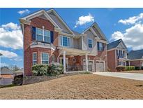 Beautiful two-story brick home with a well-manicured lawn and charming front porch at 980 Yancey Ct, Loganville, GA 30052