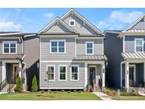 Charming two-story home with gray siding, white trim, and a well-maintained lawn at 1929 Quarry Park Nw Pl, Atlanta, GA 30318