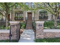 Charming brick townhome with a wrought iron fence and beautifully landscaped front yard at 8 Honour Nw Ave # 6, Atlanta, GA 30305