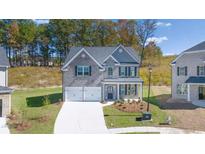 Charming two-story home with a two car garage, neutral paint and manicured landscaping at 1858 Lacebark Elm Way, Lawrenceville, GA 30045