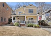 Charming yellow two-story home with a welcoming front porch and landscaped front yard at 286 Candler Ne St, Atlanta, GA 30307