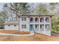 Charming two-story home with inviting blue door and upper-level balconies at 3186 Quail Ct, Decatur, GA 30034