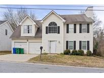 Charming two-story home with attached garage and traditional architectural details at 3958 Waldrop Hills Dr, Decatur, GA 30034