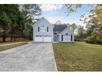 Charming two-story home with a well-manicured lawn, two car garage, and welcoming curb appeal at 3568 Foxworth Ct, Buford, GA 30519