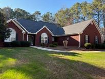 Charming brick home with well-manicured lawn and mature landscaping at 625 Huiet Dr, Mcdonough, GA 30252