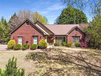 Charming brick home featuring a well-maintained lawn and lush landscaping at 1252 Highfield Dr, Lawrenceville, GA 30043