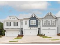Modern townhome exteriors featuring attached garages, charming designs and well-maintained landscaping at 1616 Aiden Way # 65, Conyers, GA 30013