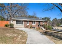 Charming brick home featuring a long driveway and well-maintained front yard at 3140 Westmart Ln, Atlanta, GA 30340