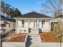 Charming home featuring a welcoming front porch and well-maintained landscaping with inviting curb appeal at 1024 Herndon Nw St, Atlanta, GA 30318