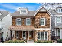 Charming craftsman-style home with cedar shake siding, stone accents, and inviting front porch at 1918 Coal Pl, Atlanta, GA 30318