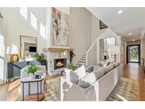 Bright living room features a stone fireplace, high ceilings, and comfortable seating arrangement at 886 Cedar Creek Se Ct, Marietta, GA 30067