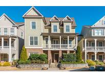 Charming two-story home featuring a covered front porch, brick accents, and well-maintained landscaping at 1329 Booth Ave, Atlanta, GA 30318