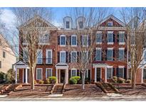 Charming brick townhomes featuring black shutters and well-maintained landscaping at 4305 Kendall Way, Roswell, GA 30075
