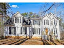 Charming two-story home featuring classic design elements and a well-maintained yard at 582 Black Forest Run, Douglasville, GA 30134