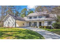 Charming two-story home with a well-manicured lawn and inviting curb appeal at 180 Stone Mill Trl, Atlanta, GA 30328