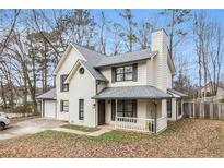 Charming two-story home with white siding, brick accents, and inviting front porch at 9556 River Ct, Jonesboro, GA 30238