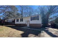 Traditional home featuring white siding, black shutters, and a well-maintained front yard at 893 Boca Raton Dr, Forest Park, GA 30297