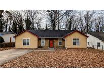 Charming single-story home with a well-maintained lawn and stone accents at 1343 Willow Sw Trl, Atlanta, GA 30311