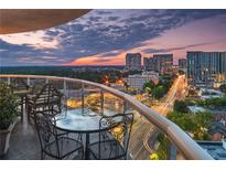 Expansive balcony featuring outdoor seating, city views, and a stunning sunset backdrop at 2881 Peachtree Ne Rd # 1001, Atlanta, GA 30305