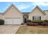 Charming home featuring a two-car garage, manicured lawn, and inviting entrance at 503 Goldfinch Way, Stockbridge, GA 30281