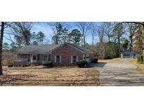 Charming brick home with a well-manicured lawn, garage and separate storage space at 2539 Britt Rd, Snellville, GA 30078