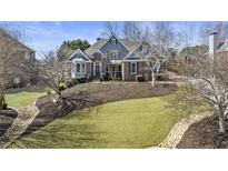 Charming two-story home features a landscaped front yard, brick accents, and a welcoming entrance at 3825 Bishops Walk, Cumming, GA 30041