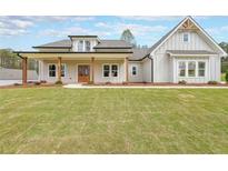 Charming single-Gathering home featuring a welcoming front porch and a well-manicured lawn at 46 Lexie Ct, Rockmart, GA 30153