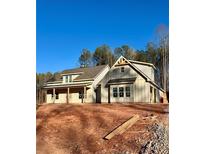 Stunning new construction home with board and batten siding, gable details, and a covered front porch at 46 Lexie Ct, Rockmart, GA 30153