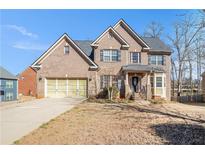 Charming brick two-story home with well-manicured lawn and attached two-car garage at 145 Windward Hls, Mcdonough, GA 30253